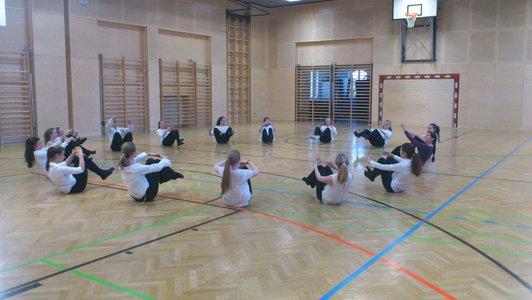 Foto mit SchülerInnen beim Aufwärmen im Turnsaal