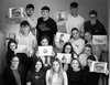 SchwarzweissFoto von Schüler/innen die eigene  schwarzweiss Fotos in Händen halten
