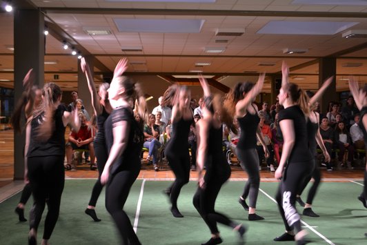 Foto von 10 Schülerinnen, die in der Aula der Schule performen